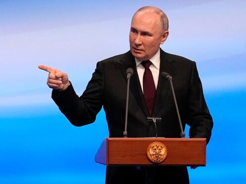 Russian President Vladimir Putin gestures while speaking on a visit to his campaign headquarters in Moscow after the presidential election (Alexander Zemlianichenko/AP)