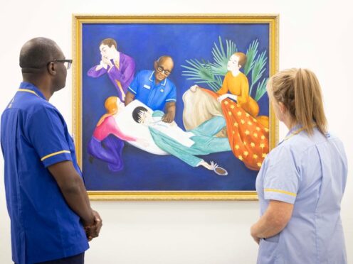 Senior Marie Curie nurse Isaac Otengo and healthcare assistant Wendy Phillips look at Lisa Buchanan’s reimagining of Nils Dardel’s The Dying Dandy (Matt Alexander/PA)