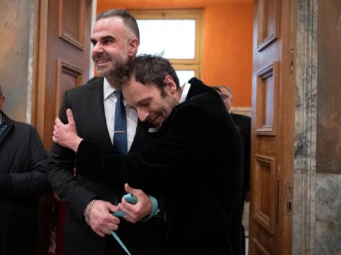 Greek author Petros Hadjopoulos hugs his husband lawyer Anastasios Samouilidis (Michael Varaklas/AP)
