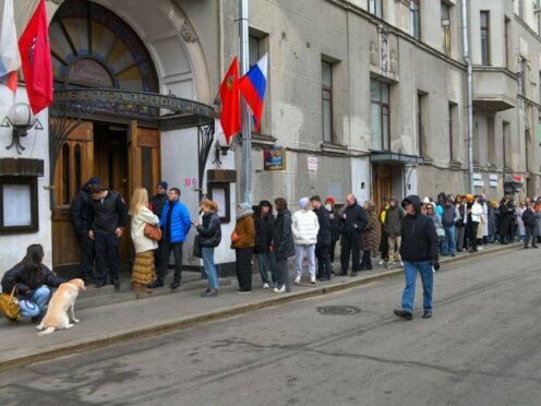 Voters queue at a polling station at noon local time in Moscow, Russia (AP)