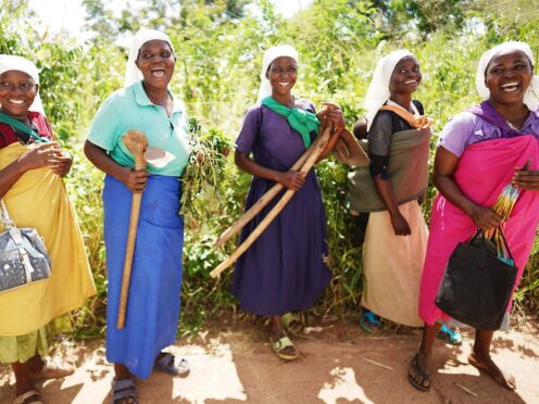 Women carrying farming tools in the Balaka district of Malawi (Brian Lawless/PA)