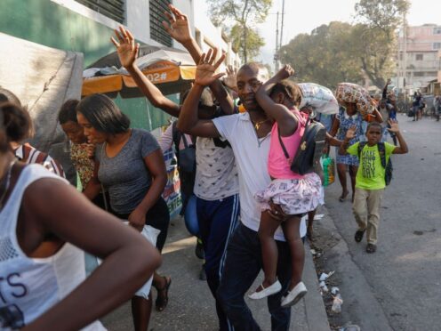 Residents flee their homes during clashes between police and gang members in the Portail neighbourhood in Port-au-Prince, Haiti (Odelyn Joseph/AP)