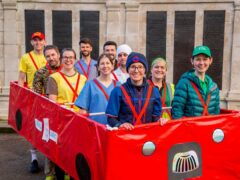 Jackie Scully (front left) is set to tackle the 2024 London Marathon in a 10-peron red bus costume (Ed Roe/PA)
