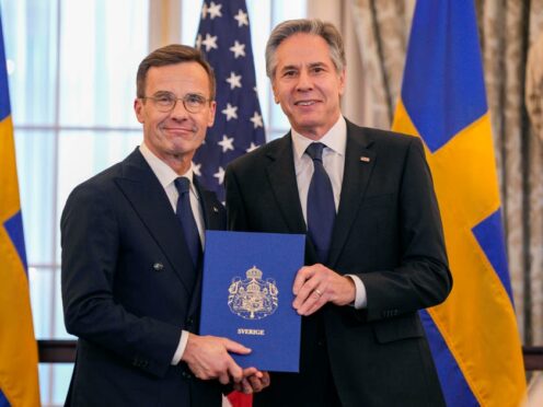 Secretary of State Antony Blinken poses for a photo with Swedish Prime Minister Ulf Kristersson holding Sweden’s Nato instruments of accession (Jess Rapfogel/AP)