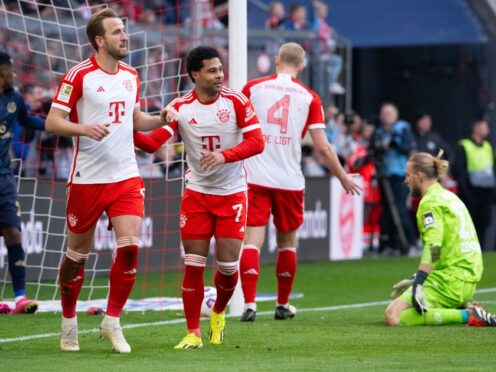 Harry Kane, left, scored a hat-trick in Bayern Munich’s 8-1 Bundesliga win over Mainz (Sven Hoppe/AP/PA)