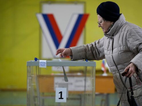 A woman casts a ballot (Dmitri Lovetsky/AP)