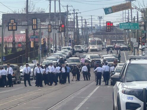 Police and officials gather on a cordoned off street at the scene of a shooting in Philadelphia (Claudia Lauer/AP)