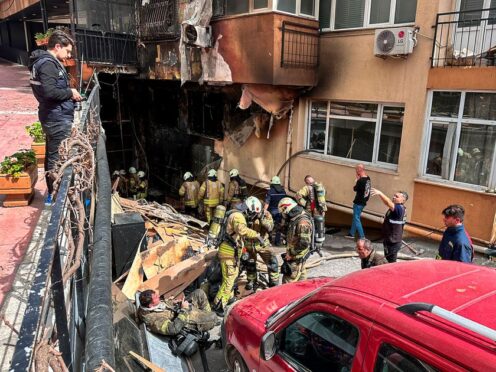 Firefighters work after a fire broke out at a nightclub in Istanbul (IHA via AP)