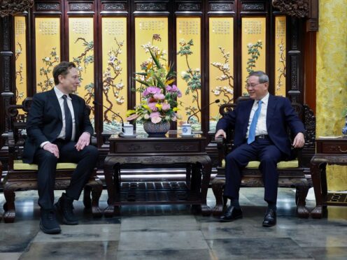 Tesla founder Elon Musk, left, meets with Chinese Premier Li Qiang in Beijing (Wang Ye/Xinhua via AP)