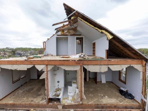 A partially torn off roof is seen on a damaged home in Omaha, Nebraska (Chris Machian/Omaha World-Herald via AP)