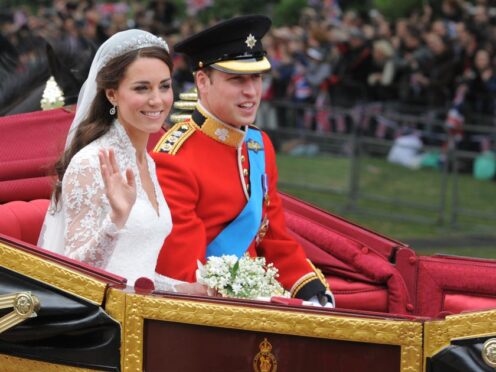 Kate and William travel in the 1902 State Landau along the processional route to Buckingham Palace after their wedding (Dimitar Dilkoff/PA)