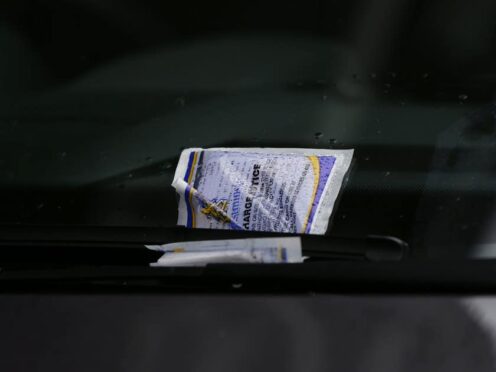 A parking ticket placed on the windscreen of a car in Westminster, London.