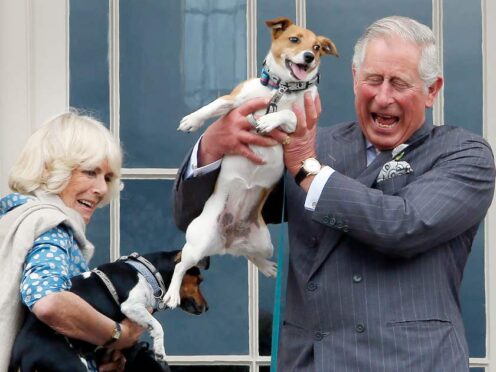 Charles and Camilla hold the Camilla’s dogs Beth (left) and Bluebell (right) (Danny Lawson/PA)