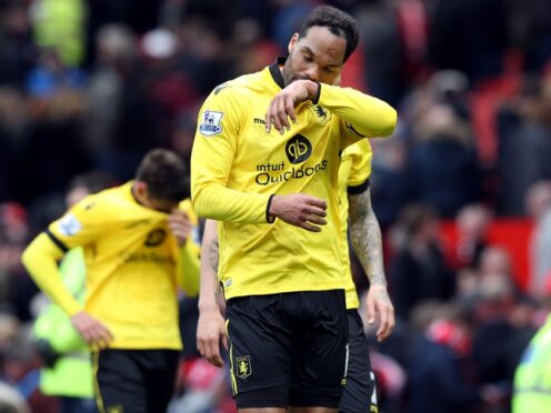 Joleon Lescott reacts after Aston Villa’s defeat at Manchester United confirmed their relegation (Martin Rickett/PA)