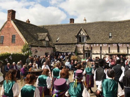 Molly dancers perform as people celebrate St George’s Day and the official start of the asparagus season at the The Fleece Inn in Bretforton, Worcestershire.
