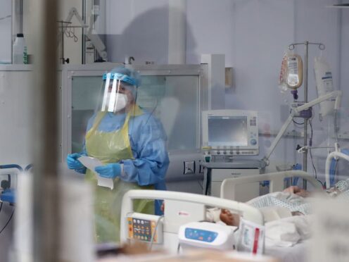 A member of the intensive care team treats Covid-19 patients at Craigavon Area Hospital in May 2020 (Niall Carson/PA)