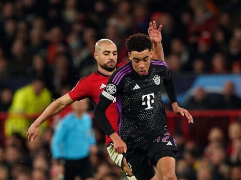Manchester United’s Sofyan Amrabat (left) tackles Bayern Munich’s Jamal Musiala (Martin Rickett, PA)
