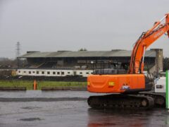 Contractors with excavators have begun clearing the concrete seating terraces at GAA stadium in Belfast (PA)