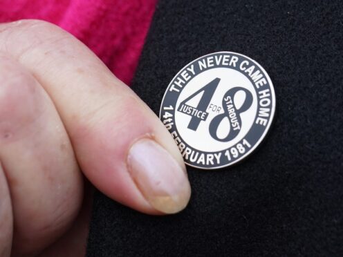 A family member touches her Stardust lapel pin on gher way into Dublin Coroner’s Court where the coroner in the Stardust inquest is due to charge the jury. Picture date: Thursday March 28, 2024.