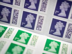 Royal Mail is to temporarily pause the collection of the £5 surcharge for those who receive post with a counterfeit stamp (James Manning/PA)