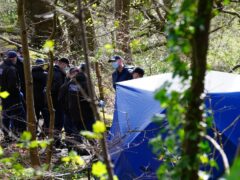 Police officers by a forensic tent at Kersal Dale (Peter Byrne/PA)