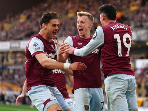 West Ham United’s James Ward-Prowse (centre) celebrates with Konstantinos Mavropanos (left) and Edson Alvarez after scoring their second goal of the game during the Premier League match at Molineux, Wolverhampton. Picture date: Saturday April 6, 2024.