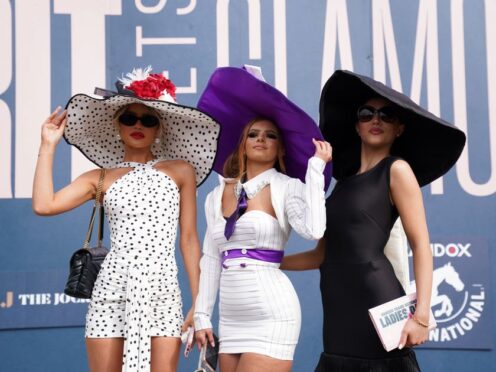 Racegoers arrive on day two of the 2024 Randox Grand National Festival at Aintree Racecourse in Liverpool (Bradley Collyer/PA)