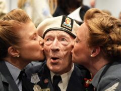 D-Day veteran Alec Penstone, 98, receives a kiss from the D-Day Darlings at the D-Day 80 launch event (Gareth Fuller/PA)