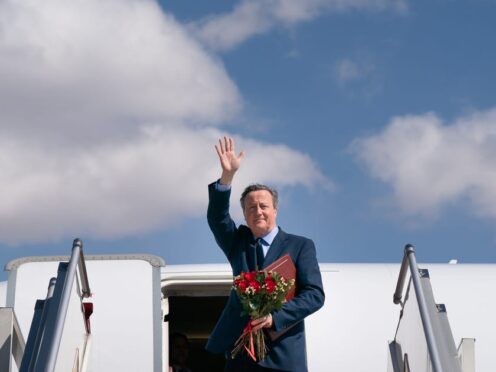Foreign Secretary Lord David Cameron waves as he boards his plane in Ulaanbaatar, Mongolia, on the last day of his five day tour of the Central Asia region (Stefan Rousseau/PA)