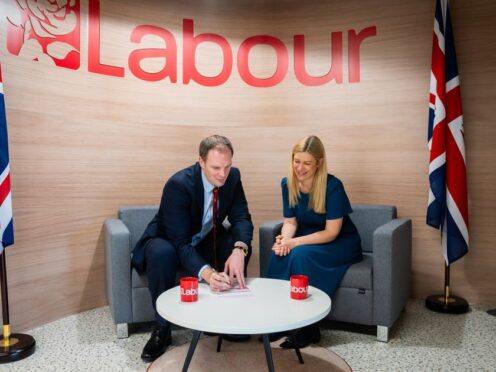 Dr Dan Poulter signing his Labour Party membership form with Ellie Reeves, Labour’s deputy national campaign co-ordinator (Labour Party/PA)