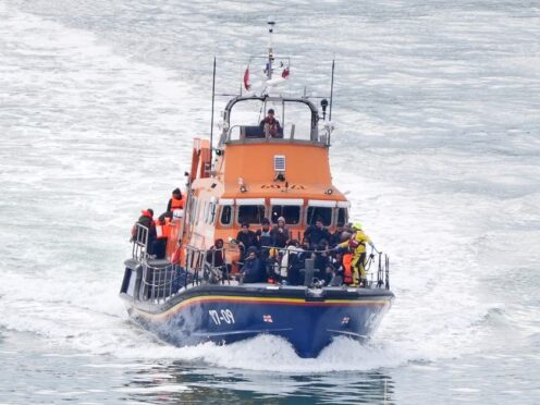 A group of people thought to be migrants are brought in to Dover, Kent, onboard the RNLI Dover Lifeboat following a small boat incident in the Channel (Gareth Fuller/PA)