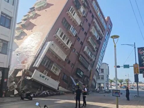 In this image taken from a video footage run by TVBS, a partially collapsed building is seen in Hualien, eastern Taiwan (TVBS/AP)