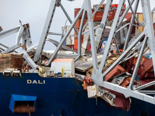 A section of the container ship Dali is seen with the collapsed Francis Scott Key Bridge on it, as seen from the debris retrieval vessel Reynolds (Kaitlin Newman/The Baltimore Banner/AP)
