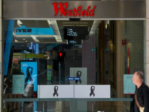 A man walks past the entrance to the Westfield shopping centre at Bondi Junction in Sydney (Mark Baker/AP)