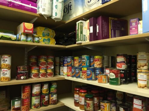 A secondary school store cupboard for tinned foods, cereal, baby food, toilet roll, and nappies used to create parcels for families of pupils in need (University of Bristol/PA)