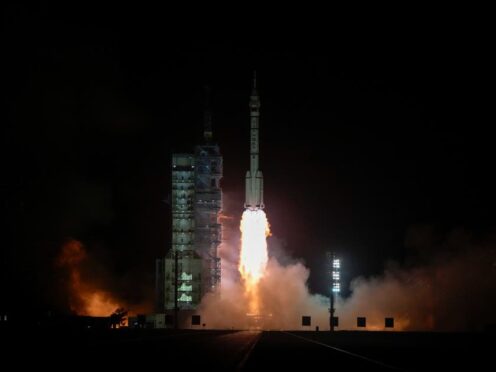 A Long March rocket carrying a crew of Chinese astronauts in a Shenzhou-18 spaceship (Andy Wong/AP)