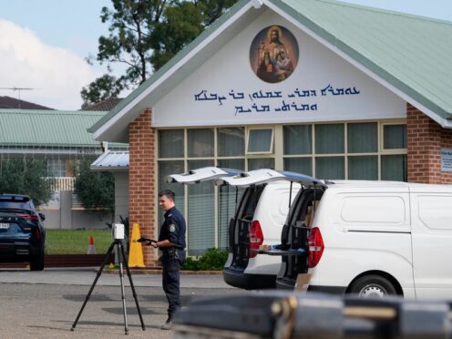 A police forensic officer works at a crime scene at the Christ the Good Shepherd Church in Wakely in western Sydney, Australia (Mark Baker/AP)