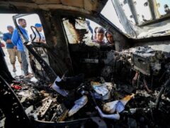 People inspect the site where World Central Kitchen workers were killed in Deir al-Balah, Gaza Strip (Abdel Kareem Hana/AP)