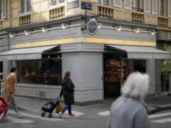 Parisians walk by the Utopie bakery in Paris (Thibault Camus/AP)