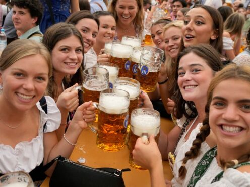 Women with glasses of beer on day one of the 188th Oktoberfest beer festival in Munich, Germany, in 2023 (Matthias Schrader/AP)