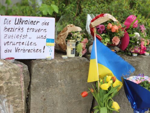 Flowers and a small Ukrainian flag were left at the scene (dpa via AP)