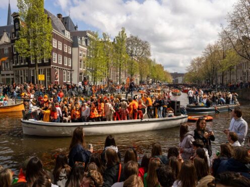 People dance on a boat during King’s Day celebrations in Amsterdam on Saturday (Peter Dejong/AP)