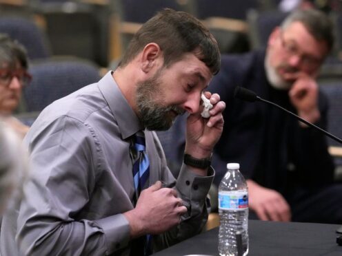 Sean Hodgson wipes tears while recalling the moment he heard about the mass shooting (Robert F Bukaty/AP)