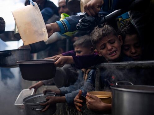 Palestinians line up for a meal in Rafah, Gaza Strip (Fatima Shbair/AP)
