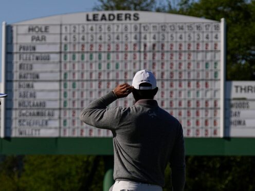 Tiger Woods looks at the leader board on the 18th hole as he eyes a sixth Masters title (George Walker IV/AP)
