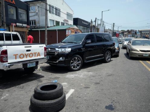 Cars queue to buy fuel at a petrol station in Lagos, Nigeria (Sunday Alamba/AP)