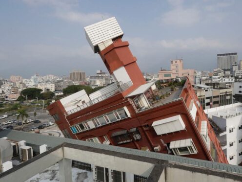 A partially collapsed building stands at a titled angle a day after a powerful earthquake struck in Hualien City, eastern Taiwan (Chiang Ying-ying/AP)