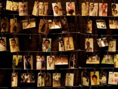 Family photographs of some of those who died on display in an exhibition at the Kigali Genocide Memorial centre (Ben Curtis/AP)