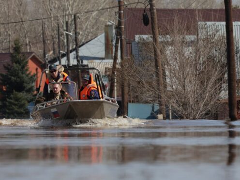 Russian Emergency Situation Ministry rescuers ride a boat to help local residents during evacuations from a flooded area in Orenburg, Russia (AP)