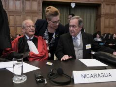 Nicaragua’s Ambassador Carlos Jose Arguello Gomez, right, and Alain Pellet, left, a lawyer representing Nicaragua, wait for the start of a two day hearing at the World Court in The Hague, Netherlands (Patrick Post/AP)